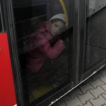 
              A young girl who fled the war in Ukraine sits on a bus to leave Korczowa border crossing, Poland, Sunday, March 6, 2022. The number of Ukrainians forced from their country increased to 1.5 million and the Kremlin's rhetoric grew, with Russian President Vladimir Putin warning that Ukrainian statehood is in jeopardy. He likened the West's sanctions on Russia to "declaring war." (AP Photo/Czarek Sokolowski)
            
