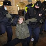 
              FILE - Police officers detain a demonstrator holding a sign reading 'No war!' during an action against Russia's attack on Ukraine in St. Petersburg, Russia, Feb. 24, 2022. (AP Photo, File)
            