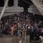 
              Ukrainians crowd under a destroyed bridge as they try to flee crossing the Irpin river in the outskirts of Kyiv, Ukraine, Saturday, March 5, 2022. (AP Photo/Emilio Morenatti)
            