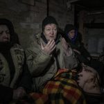 
              A woman gestures in the small basement of a house crowded with people seeking shelter from Russian airstrikes and shelling in Gorenka, outside the capital Kyiv, Ukraine, Wednesday, March 2, 2022. Russia renewed its assault on Ukraine's second-largest city in a pounding that lit up the skyline with balls of fire over populated areas, even as both sides said they were ready to resume talks aimed at stopping the new devastating war in Europe.(AP Photo/Vadim Ghirda)
            
