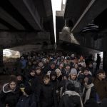 
              Ukrainians crowd under a destroyed bridge as they try to flee crossing the Irpin river in the outskirts of Kyiv, Ukraine, Tuesday, March 8, 2022. Demands for ways to safely evacuate civilians have surged along with intensifying shelling by Russian forces, who have made significant advances in southern Ukraine but stalled in some other regions. Efforts to put in place cease-fires along humanitarian corridors have repeatedly failed amid Russian shelling. (AP Photo/Felipe Dana)
            