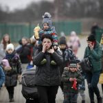 
              Refugees, mostly women with children, arrive at the border crossing in Medyka, Poland, Saturday, March 5, 2022, after fleeing Russian invasion in Ukraine. (AP Photo/Visar Kryeziu)
            