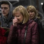 
              A displaced Ukrainian woman cries as she waits to get on a train to Poland, at the Lviv railway station, in Lviv, western Ukraine, Thursday, March 3, 2022. Russia’s invasion of Ukraine has forced more than a million people to flee their homeland in just a week. (AP Photo/Bernat Armangue)
            