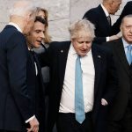 From left, U.S. President Joe Biden, French President Emmanuel Macron, British Prime Minister Boris Johnson and Turkish President Recep Tayyip Erdogan walk off the podium after a group photo during an extraordinary NATO summit at NATO headquarters in Brussels, Thursday, March 24, 2022. As the war in Ukraine grinds into a second month, President Joe Biden and Western allies are gathering to chart a path to ramp up pressure on Russian President Vladimir Putin while tending to the economic and security fallout that's spreading across Europe and the world. (AP Photo/Thibault Camus)