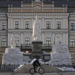 
              A man rides a bicycle backdropped by a statue of Grand Princess Olga of Kyiv, in the process of being covered in sandbags to avoid damage from potential shelling, in Kyiv, Ukraine, Monday, March 28, 2022. Ukraine is prepared to declare its neutrality and consider a compromise on contested areas in the country's east, President Volodymyr Zelenskyy said ahead of another round of talks set for Tuesday on stopping the fighting. (AP Photo/Vadim Ghirda)
            