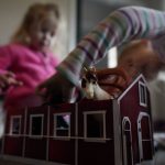 
              Alyssa Carpenter, 2, and her sister Audrey Carpenter, 5, play with toy horses on the floor of the home office of their mother, Tara Carpenter, in Haymarket, Va., Friday, Jan. 28, 2022. Alyssa has had COVID-19 twice and suffers long-term symptoms. She and her two sisters are part of a NIH-funded multi-year study at Children's National Hospital to look at impacts of COVID-19 on children's physical health and quality of life. (AP Photo/Carolyn Kaster)
            