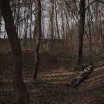 
              The bodies of two Russian soldiers are seen at the woods in Trostsyanets, Ukraine, Monday, March 28, 2022. Trostsyanets was recently retaken by Ukrainian forces after being held by Russians since the early days of the war. (AP Photo/Felipe Dana)
            