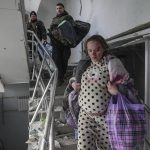 
              An injured pregnant woman walks downstairs in the damaged by shelling maternity hospital in Mariupol, Ukraine, Wednesday, March 9, 2022. A Russian attack has severely damaged a maternity hospital in the besieged port city of Mariupol, Ukrainian officials say. (AP Photo/Evgeniy Maloletka)
            