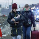 
              A girl from Ukraine holds a dog as she arrives with another woman to the border crossing in Medyka, southeastern Poland, Wednesday, March 2, 2022. The U.N. refugee agency said Tuesday that about 660,000 people have fled Ukraine for neighboring countries since the invasion began. (AP Photo/Visar Kryeziu)
            