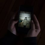 
              Hanna Tverdokhlib, a 37-year-old Ukrainian immigrant, shows a photo of her aunt hunkering down in a basement of her apartment building in Kyiv, Ukraine, Thursday, March 3, 2022, in Long Beach, Calif. Tverdokhlib has held her phone as if it were glued to her hand since the Russian invasion of Ukraine last week. When she isn't watching news on it, she is texting her cousins and close friends back home or checking their Facebook posts, hoping her cousins are still safe in the bunker underneath their Kyiv apartment building where they run when the sirens go off. (AP Photo/Jae C. Hong)
            