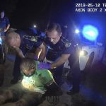 
              FILE - This image from the body camera of Louisiana State Police Trooper Dakota DeMoss shows his colleagues, Kory York, center left, and Chris Hollingsworth, center right, holding up Ronald Greene before paramedics arrived on May 10, 2019, outside of Monroe, La. Widely seen as the most culpable of the half-dozen officers involved, Hollingsworth can’t face justice because he died just six days after an interrogation from a high-speed, single-vehicle, crash that came hours after he was told he would be fired for his role in Greene’s arrest. (Louisiana State Police via AP, File)
            