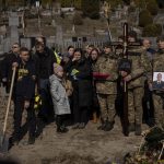 
              Relatives and friends attend the funeral of Ukrainian military servicemen Rostyslav Romanchuk in Lviv, Ukraine, Tuesday, March 15, 2022. Romanchuk was killed during Sunday's Russian missile strike on a military training base near Ukraine's western border with NATO member Poland. (AP Photo/Bernat Armangue)
            