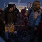 
              Refugees who fled the war from Ukraine wait in line at the Medyka border crossing in Poland, on Saturday, March 12, 2022. Russian troops are pressing their offensive across Ukraine, pounding populated areas with artillery and airstrikes and deploying siege tactics honed in Syria and Chechnya — where opposing cities were reduced to rubble. (AP Photo/Petros Giannakouris)
            