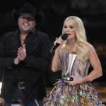 
              Jason Aldean, left, and Carrie Underwood accept the award for single of the year for "If I Didn't Love You" at the 57th Academy of Country Music Awards on Monday, March 7, 2022, at Allegiant Stadium in Las Vegas. (AP Photo/John Locher)
            