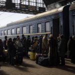 
              Ukrainians escaping from the besieged city of Mariupol along with other passengers from Zaporizhzhia gather on a train station platform after arriving at Lviv, western Ukraine, on Sunday, March 20, 2022. (AP Photo/Bernat Armangue)
            