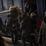 
              Ukrainians escaping from the besieged city of Mariupol along with other passengers from Zaporizhzhia arrive at Lviv, western Ukraine, on Sunday, March 20, 2022. (AP Photo/Bernat Armangue)
            