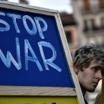 
              A Ukrainian man holds a banner while taking part in a protest against Russia's invasion of Ukraine, in Pamplona, northern Spain, Saturday, March 12, 2022. (AP Photo/Alvaro Barrientos)
            