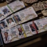 
              Fake IDs depicting Russian President Vladimir Putin, left, Belarusian President Alexander Lukashenko, center, and US President Joe Biden for sale in a flea market in Lviv, western Ukraine, on Sunday, March 20, 2022. . (AP Photo/Bernat Armangue)
            