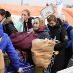 
              Refugees stand in a queue with their belongings after fleeing the war from neighbouring Ukraine at the border crossing in Medyka, southeastern Poland, on Tuesday, March 29, 2022. The daily number of people fleeing Ukraine has fallen in recent days but border guards, aid agencies and refugees say Russia's unpredictable war offers few signs whether it's just a temporary lull or a permanent drop-off. (AP Photo/Sergei Grits)
            