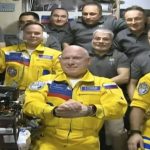
              In this frame grab from video provided by Roscosmos, Russian cosmonauts Sergey Korsakov, Oleg Artemyev and Denis Matveyev are seen during a welcome ceremony after arriving at the International Space Station, Friday, March 18, 2022, the first new faces in space since the start of Russia’s war in Ukraine. The crew emerged from the Soyuz capsule wearing yellow flight suits with blue stripes, the colors of the Ukrainian flag. (Roscosmos via AP)
            