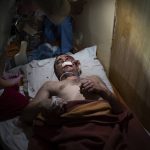 
              Medical workers treat a man, wounded by shelling, in a hospital in Mariupol, Ukraine, Friday, March 4, 2022. (AP Photo/Mstyslav Chernov)
            