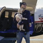 Pilots To The Rescue "Top Dog" Michael Schneider gets puppy kisses from Moira, an 8 week old Labrador puppy, as they arrive at Tipton Airport in Fort Meade, Md., Tuesday, Feb. 8, 2022. Moira, part of the Guiding Eyes for the Blind puppy program, will be handed off to her volunteer "Puppy Raiser." Guiding Eyes for the Blind provides guide dogs to people with vision loss and vision impairment at no cost to the recipient. (AP Photo/Carolyn Kaster)