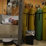 
              Lexie Stroiney, 6, curls up in the plethysmography chamber during a break in her pulmonary function test at Children's National Hospital, in Washington, Wednesday, Jan. 26, 2022. Lexie had COVID-19 and is part of a NIH-funded multi-year study at Children's National Hospital to look at impacts of COVID-19 on children's physical health and quality of life. (AP Photo/Carolyn Kaster)
            