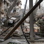 
              Andrey Goncharuk, 68, a member of the territorial defense stands in the backyard of a house damaged by a Russian airstrike, according to locals, in Gorenka, outside the capital Kyiv, Ukraine, Wednesday, March 2, 2022. Russia renewed its assault on Ukraine's second-largest city in a pounding that lit up the skyline with balls of fire over populated areas, even as both sides said they were ready to resume talks aimed at stopping the new devastating war in Europe. (AP Photo/Vadim Ghirda)
            