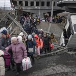 
              People cross on an improvised path under a bridge that was destroyed by a Russian airstrike, while fleeing the town of Irpin, Ukraine, Saturday, March 5, 2022. What looked like a breakthrough cease-fire to evacuate residents from two cities in Ukraine quickly fell apart Saturday as Ukrainian officials said shelling had halted the work to remove civilians hours after Russia announced the deal. (AP Photo/Vadim Ghirda)
            