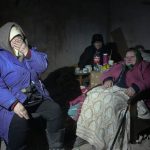 
              Elderly residents hide in a basement for shelter, with no electricity, water or food in the center of the town of Irpin, some 25 km (16 miles) northwest of Kyiv, Friday, March 11, 2022. Kyiv northwest suburbs such as Irpin and Bucha have been enduring Russian shellfire and bombardments for over a week. (AP Photo/Efrem Lukatsky)
            