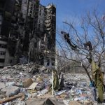 
              Clothes thrown by the Russian shelling from the ruined house hang on a tree in Kharkiv, Ukraine, Saturday, March 26, 2022. (AP Photo/Efrem Lukatsky)
            