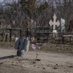 
              A part of a rocket sits wedged on the ground following a Russian bombing earlier this week, at a cemetery in Mykolaiv, Ukraine, Saturday, March 26, 2022.(AP Photo/Petros Giannakouris)
            