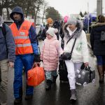 
              Refugees fleeing the conflict from neighbouring Ukraine carry bags shortly after crossing the border in Siret, Romania, Wednesday, March 2, 2022. The U.N. refugee agency says more than 874,000 people have fled Ukraine since Russia's invasion last week and the figure is "rising exponentially," putting it on track to cross the 1 million mark possibly within hours. (AP Photo/Renata Brito)
            