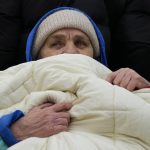 
              A man is bundled in a blanket as he waits in a queue after fleeing the war from neighbouring Ukraine, at the border crossing in Medyka, southeastern Poland, on Tuesday, March 29, 2022. The daily number of people fleeing Ukraine has fallen in recent days but border guards, aid agencies and refugees say Russia's unpredictable war offers few signs whether it's just a temporary lull or a permanent drop-off. (AP Photo/Sergei Grits)
            