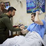 
              In this photo provided by the Ukrainian Presidential Press Office on Sunday, March 13, 2022, President Volodymyr Zelenskyy, center, shakes hands with a wounded soldier during his visit to a hospital in Kyiv, Ukraine. (Ukrainian Presidential Press Office via AP)
            