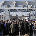 
              FILE - Vice President Joe Biden and U.S. Rep. John Lewis, D-Ga., lead a group across the Edmund Pettus Bridge in Selma, Ala., on March 3, 2013. Vice President Kamala Harris is traveling to Alabama this weekend to commemorate a key moment of the civil rights movement. Harris will speak in Selma at an event marking the 57th anniversary of “Bloody Sunday,” the day in 1965 when white police attacked Black voting rights marchers. (AP Photo/Dave Martin, File)
            