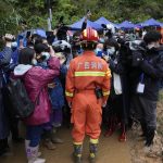 
              A rescue team member briefs media near the China Eastern crash site, Thursday, March 24, 2022, in Molang village, in southwestern China's Guangxi province. The search area was expanded Thursday in a "blanket search" for the second black box from a China Eastern passenger plane that crashed in southern China with 132 people on board earlier this week, state media said (AP Photo/Ng Han Guan)
            