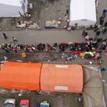 
              An aerial view of refugees queuing for transport at the border crossing at Medyka, Poland, Sunday March 13, 2022, where the main flow of Ukrainian refugees cross into Poland. The U.N. refugee agency says more than 2.5 million people, including more than a million children, have already fled Ukraine. It has become an unprecedented humanitarian crisis in Europe and the fastest refugee exodus since World War II. (AP Photo)
            