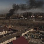 
              Smoke billows from burning containers after shelling in Vasylkiv, south west of Kyiv, Ukraine, Saturday, March 12, 2022. Russian forces appeared to make progress from northeast Ukraine in their slow fight to reach the capital, Kyiv, while tanks and artillery pounded places already under siege. (AP Photo/Felipe Dana)
            