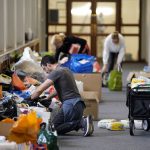 
              Volunteers help sort through fresh donations after more than 500 boxes of essential supplies were gathered by Parenting Network at Portsmouth Guildhall, Britain, Thursday March 3, 2022.. So far, more than £3,000 in funding has been raised, and all donated supplies are planned to be sent to the Polish-Ukrainian border. (Andrew Matthews/PA via AP)
            