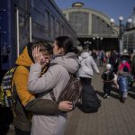 
              A mother embraces her son who escaped the besieged city of Mariupol and arrived at the train station in Lviv, western Ukraine on Sunday, March 20, 2022. (AP Photo/Bernat Armangue)
            