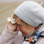 
              A woman named Svetlana, who traveled from Kharkiv, cries as she waits in a queue with other fleeing the war from neighbouring Ukraine, at the border crossing in Medyka, southeastern Poland, on Tuesday, March 29, 2022. The daily number of people fleeing Ukraine has fallen in recent days but border guards, aid agencies and refugees say Russia's unpredictable war offers few signs whether it's just a temporary lull or a permanent drop-off. (AP Photo/Sergei Grits)
            