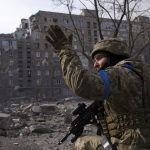 
              A Ukrainian serviceman guards his position in Mariupol, Ukraine, Saturday, March 12, 2022. Ukrainian military says Russian forces have captured the eastern outskirts of the besieged city of Mariupol. In a Facebook update Saturday, the military said the capture of Mariupol and Severodonetsk in the east were a priority for Russian forces. Mariupol has been under siege for over a week, with no electricity, gas or water. (AP Photo/Mstyslav Chernov)
            