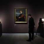 
              A visitor looks at ' Portrait of Count Nikolaj Dimitrevic Guriev ' artwork by Jean Auguste Dominique Ingres, belonging to the Hermitage Museum, at the Gallerie d'Italia museum, in Milan, Italy, Thursday, March 10, 2022. Russian cultural officials have asked for the return 25 works of art on loan to two shows in Milan this month, while the shows are still open and ahead of agreed terms, officials said Thursday. The works include two on display at a show on the Renaissance artist Titian at the city-run Palazzo Reale, including Titian's "Young woman with the feathered hat," that belongs to the Hermitage Museum as well as 23 works on display at Banca Intesa Sanpaolo's Gallerie d'Italia including a Canova sculpture, also belonging to the Hermitage. (AP Photo/Luca Bruno)
            