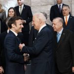 U.S. President Joe Biden, front right, speaks with French President Emmanuel Macron, front left, prior to a group photo during an extraordinary NATO summit at NATO headquarters in Brussels, Thursday, March 24, 2022. As the war in Ukraine grinds into a second month, President Joe Biden and Western allies are gathering to chart a path to ramp up pressure on Russian President Vladimir Putin while tending to the economic and security fallout that's spreading across Europe and the world. (AP Photo/Thibault Camus)
