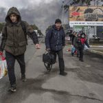 
              People leave the town of Bucha, close to Kyiv, Ukraine, Friday, March 4, 2022. (AP Photo/Oleksandr Ratushniak)
            