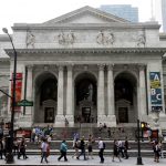 FILE - Pedestrians walk past the main branch of the New York Public Library in New York on July 22, 2013. (AP Photo/Seth Wenig, File)