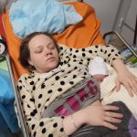 
              Mariana Vishegirskaya lies in a hospital bed after giving birth to her daughter Veronika, in Mariupol, Ukraine, Friday, March 11, 2022. Vishegirskaya survived the Russian airstrike on a children’s and maternity hospital in Mariupol last Wednesday. (AP Photo/Evgeniy Maloletka)
            