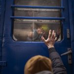 
              Stanislav, 40, says goodbye to his son David, 2, and his wife Anna, 35, on a train to Lviv at the Kyiv station, Ukraine, Thursday, March 3. 2022. Stanislav is staying to fight while his family is leaving the country to seek refuge in a neighbouring country. (AP Photo/Emilio Morenatti)
            