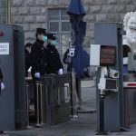 
              Chinese police officers guard one of the entrance to the Beijing No.2 Intermediate People's Court before the trial of Chinese-Australian business reporter Cheng Lei on Thursday, March 31, 2022, in Beijing. The trial of Chinese Australian journalist Cheng Lei on espionage charges began Thursday in Beijing, with diplomats denied permission to attend proceedings. (AP Photo/Ng Han Guan)
            